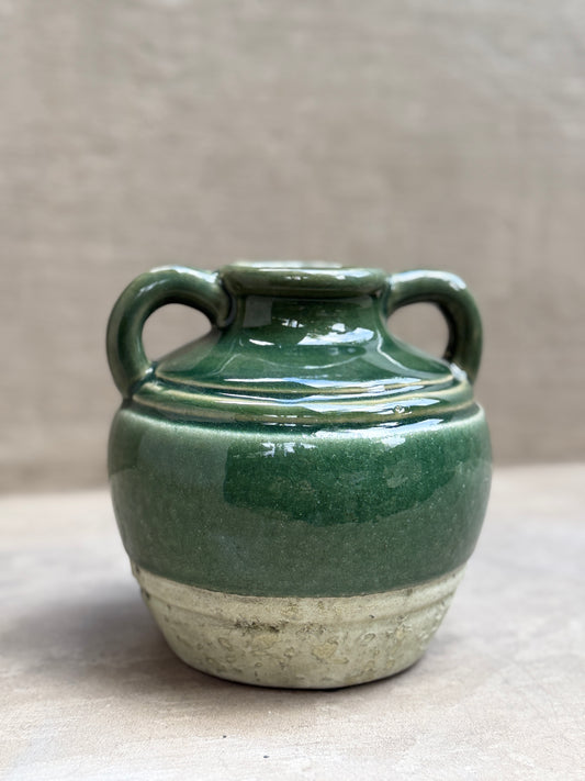 Jarrón de cerámica esmaltada verde con dos asas y base cruda