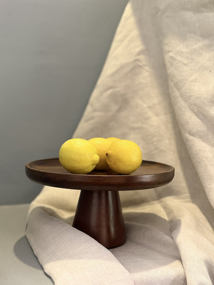 Tortero de madera con pie, con limones encima